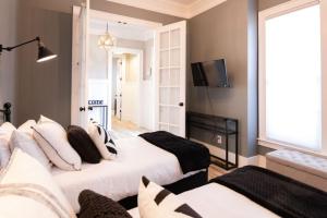 a living room with two beds and a television at Minutes to Downtown Huge Outdoor Deck HOT TUB in Nashville