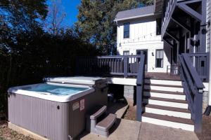 a hot tub on a deck next to a house at Minutes to Downtown Huge Outdoor Deck HOT TUB in Nashville