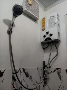 a room with a fan and a microwave on a wall at Indah Damai Cottages in Sidomukti