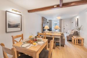 a dining room and living room with a table and chairs at Weavers Cottage Newly converted luxurious retreat in Kirkby Lonsdale