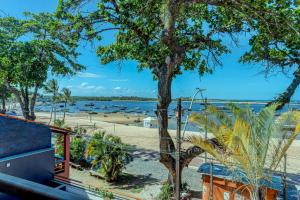 a view of a beach with boats in the water at Cairé Suites in Itacaré