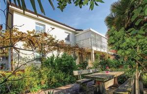 a wooden bench in front of a house at 1 Bedroom Beautiful Apartment In Lucija in Lucija