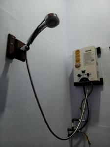 a light plugged into a wall with a cord plugged into it at Indah Damai Cottages in Sidomukti
