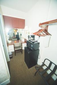 a kitchen with a stove and a chair in a room at The Chalet Motel in Mequon