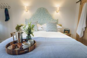 a tray of bread and croissants on a bed at The Barrington Boar in Ilminster