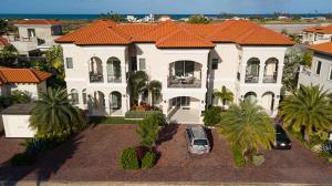 a large white house with an orange roof at Opal Rental II in Palm-Eagle Beach