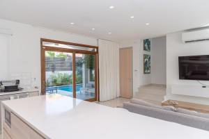 a kitchen and living room with a view of a pool at Opal Rental II in Palm-Eagle Beach