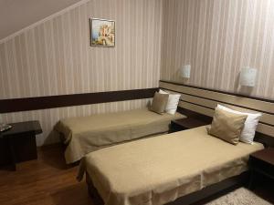 Postel nebo postele na pokoji v ubytování Mini-Hotel in Kharkiv