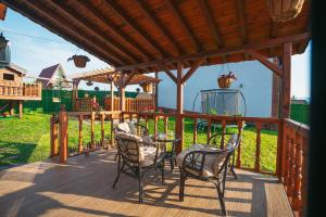 a patio with two chairs and a table on a deck at Къщи за гости 'Веринско' in Verinsko