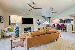 a living room with a couch and a fireplace at Condo with Community Pools and Patios in Palm Springs! in Palm Springs