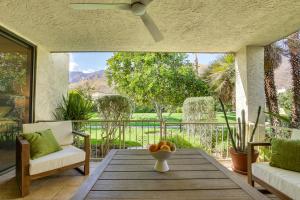 a patio with a table and a chair on a porch at Condo with Community Pools and Patios in Palm Springs! in Palm Springs