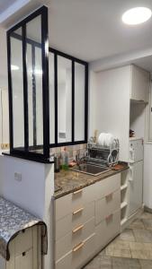 a kitchen with a sink and a counter at Roftop Mahdia in Mahdia