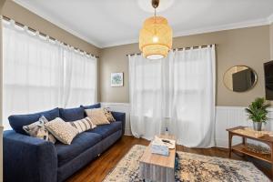 a living room with a blue couch and a table at Uptown Cottage- mins away from Downtown in Chattanooga