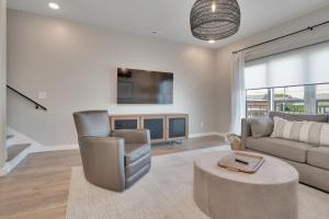 a living room with a couch and a tv at Main Street Retreat Chatt in Chattanooga