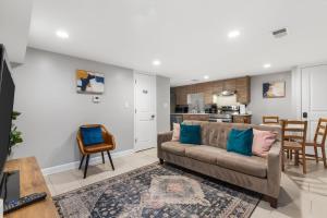 a living room with a couch and a kitchen at Walk to Parks Restaurants Monuments & More in Washington, D.C.