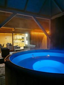 a large blue tub in a room with a kitchen at Górska Baja Premium House in Witów