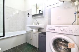 ラ・セーヌ・シュル・メールにあるEscapade cornicheの洗濯機と洗面台を備えたバスルーム