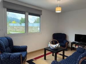 a living room with two chairs and a tv at Casa da Laurinha in Arcos de Valdevez
