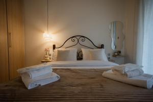 a bedroom with a bed with towels on it at 44m2 feels like home in Karditsa