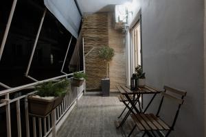 a stairway with chairs and a table and plants at 44m2 feels like home in Karditsa