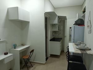 a kitchen with white cabinets and a white refrigerator at Cantinho da Paz in Sao Paulo +17 photos