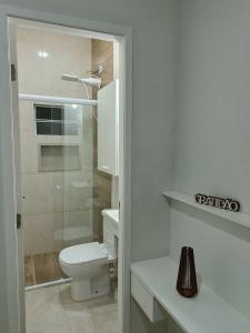 a white bathroom with a toilet and a shower at Cantinho da Paz in Sao Paulo