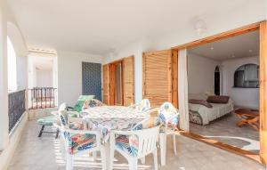 a dining room with a table and chairs and a bedroom at Gorgeous Apartment In Santa Pola in Santa Pola