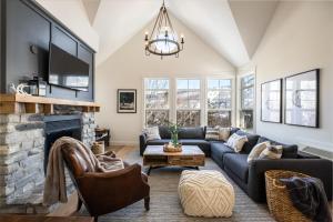 a living room with a couch and a fireplace at Tremblant Prestige - Les Eaux 233-3 in Mont-Tremblant