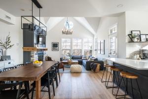 a kitchen and living room with a table and chairs at Tremblant Prestige - Les Eaux 233-3 in Mont-Tremblant +23 photos