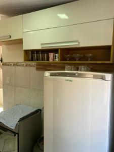 un frigorifero bianco in una cucina con di Host dos Anjos II ad Arraial do Cabo