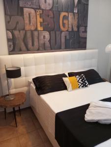 a bedroom with two beds and a painting on the wall at Machi Rooms in Patitiri +61 photos