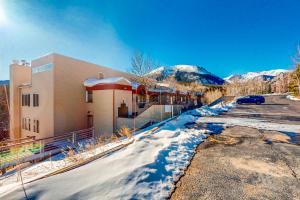 a building in the snow in front of a mountain at Watch Hill 216 in Silverthorne