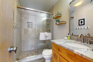 a bathroom with a shower and a sink and a toilet at Watch Hill 216 in Silverthorne +66 photos