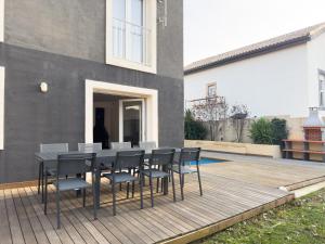 a table and chairs sitting on a wooden deck at Casa Negra in Moralzarzal