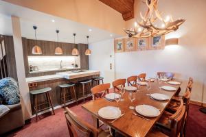a dining room with a large wooden table and chairs at 4009 loft penthouse Prince des Cimes Arc 1950 in Arc 1950