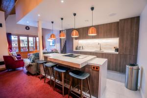 a kitchen with a large island with bar stools at 4009 loft penthouse Prince des Cimes Arc 1950 in Arc 1950