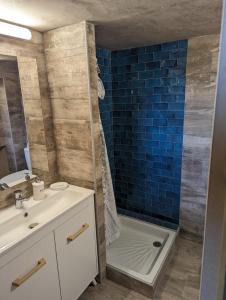 a bathroom with a sink and a shower and a tub at Petit LOFT Jardin Terrasse Climatisation WI FI Parking public gratuit in Elne +2 photos