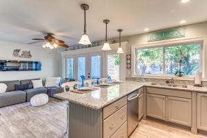 a kitchen and living room with a couch at 2 Private Outdoor Spaces Gulf Breeze Townhome! in Gulf Breeze