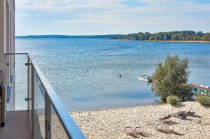 a view of a lake with a boat in the water at Boszkowo Horizon Park Apartament 27 "Romantic" in Boszkowo
