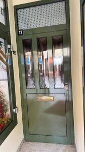 a green door of a building with a sign on it at FeWo Wittstock in Wittstock