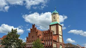 a building with a clock tower on top of it at FeWo Wittstock in Wittstock