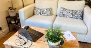 a coffee table with a laptop and a couch at AC - PRIVATE Exterior - Au pied du palais des papes! in Avignon