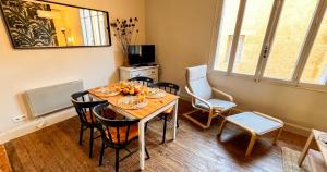 a dining room with a table and chairs at AC - PRIVATE Exterior - Au pied du palais des papes! in Avignon +35 photos