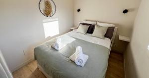 a bedroom with a large bed with towels on it at AC - PRIVATE Exterior - Au pied du palais des papes! in Avignon