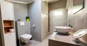 a bathroom with a white toilet and a sink at AC - PRIVATE Exterior - Au pied du palais des papes! in Avignon