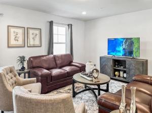 a living room with a couch and a tv at Luxurorious Townhome In Reading in Mount Penn