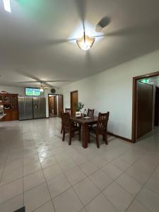 a dining room with a table and chairs and a ceiling fan at Guest Room in Kealba in St Albans