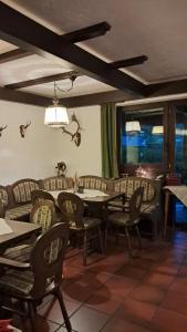 a dining room with tables and chairs and windows at Hotel-Restaurant Tannenhof in Ahrbrück