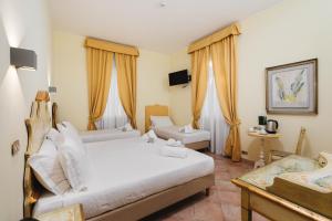 Postel nebo postele na pokoji v ubytování Sourire Hotel