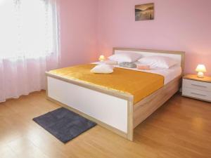 a bedroom with a large bed with white sheets at Holiday Home - Lucija in Maslenica
